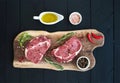 Raw fresh meat Ribeye steak entrecote and seasonings on cutting board