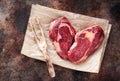 Raw fresh meat Ribeye Steak heart shape on brown paper Royalty Free Stock Photo