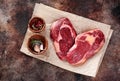 Raw fresh meat Ribeye Steak heart shape on brown paper Royalty Free Stock Photo