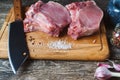 Raw fresh meat steak and meat cleaver on dark background. Butcher shop Royalty Free Stock Photo