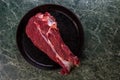 Raw Fresh Meat For The Steak New York Lies in a Cast-Iron Vintage Pan. Green Marble Table. View From Above Royalty Free Stock Photo