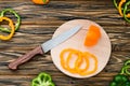 Raw fresh pepper on cutting board. Wooden table Royalty Free Stock Photo