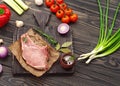 Raw fresh piece of meat on the bone with vegetables Royalty Free Stock Photo