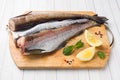 Raw fresh Pollock fish on a wooden Board with lemon Royalty Free Stock Photo