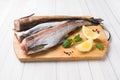 Raw fresh Pollock fish on a wooden Board with lemon Royalty Free Stock Photo