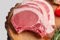 Raw fresh pork fillet steak on the bone on wooden cutting board Royalty Free Stock Photo