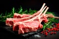 Raw fresh rack of lamb with green herbs on black background Royalty Free Stock Photo