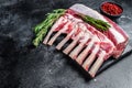 Raw fresh rack of lamb meat on marble board. Black background. Top view. Copy space Royalty Free Stock Photo