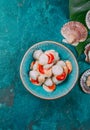 Raw fresh seafood shellfish scallops on blue background Royalty Free Stock Photo