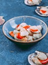 Raw fresh seafood shellfish scallops on blue background Royalty Free Stock Photo