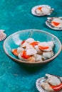 Raw fresh seafood shellfish scallops on blue background Royalty Free Stock Photo