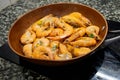 Raw fresh shrimps and langoustines on a frying pan. Close-up of the process of thermal processing of shellfish Royalty Free Stock Photo
