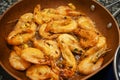 Raw fresh shrimps and langoustines on a frying pan. Close-up of the process of thermal processing of shellfish Royalty Free Stock Photo