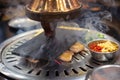 raw fresh sliced pork on hot pan and chili garlic with range hood smoke Korean-Style BBQ in a Korean restaurant. Royalty Free Stock Photo