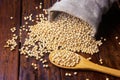 Raw and fresh soy beans in rustic fabric bag on wooden table. Closeup Royalty Free Stock Photo