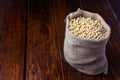 Raw and fresh soy beans in rustic fabric bag on wooden table. Closeup Royalty Free Stock Photo