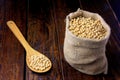 Raw and fresh soy beans in rustic fabric bag on wooden table. Closeup Royalty Free Stock Photo