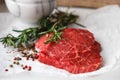 Raw fresh steaks from the marble beef, rosemary and spices Royalty Free Stock Photo