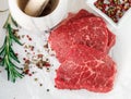 Raw fresh steaks from the marble beef, rosemary and spices . Top view Royalty Free Stock Photo