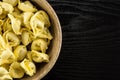 Raw Fresh tortellini pasta on black wood Royalty Free Stock Photo