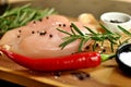 Raw fresh uncooked chicken breast meat fillet dish with rosemary, pepper, salt and red hot chili pepper