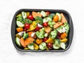 Raw fresh vegetables on a baking sheet. Sweet potato, zucchini, sweet pepper, cherry tomatoes, garlic, broccoli cabbage-ingredient Royalty Free Stock Photo