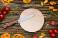 Raw fresh veggies on cutting board. Wooden table Royalty Free Stock Photo