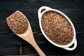 Raw fried buckwheat grains in white bowls - flat lay