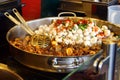 Raw and fried champignons in a frying pan Royalty Free Stock Photo