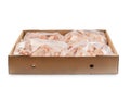 Industrial chicken selling and producing.Raw, frozen chicken wings in a cardboard box on an isolated white background Royalty Free Stock Photo