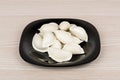 Raw frozen dumplings in black glass plate Royalty Free Stock Photo