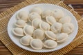 Raw frozen dumplings on  plate on table Royalty Free Stock Photo