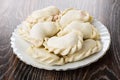 Raw frozen dumplings in plate on table Royalty Free Stock Photo