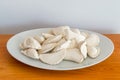 Raw frozen dumplings on white plate Royalty Free Stock Photo