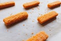 Raw frozen fish fingers on parchment paper, ready for baking Royalty Free Stock Photo