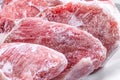 Raw frozen meat pieces. raw pork chops