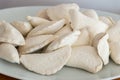 Raw frozen uncooked dumplings on white plate Royalty Free Stock Photo