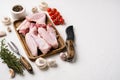 Raw goose wings, on white stone table background, with copy space for text