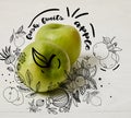 raw green apples on wooden background with floral illustration 
