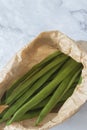 Raw green beans in a brown paper bag. Eco friendly recycling packaging