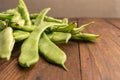 Raw green beans closeup. Fresh green bean also known as french beans, string beans, snap bean, snaps and haricots vert on wooden Royalty Free Stock Photo