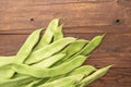 Raw green beans closeup. Fresh green bean also known as french beans, string beans, snap bean, snaps and haricots vert on wooden Royalty Free Stock Photo