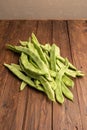 Raw green beans closeup. Fresh green bean also known as french beans, string beans, snap bean, snaps and haricots vert on wooden Royalty Free Stock Photo