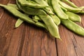 Raw green beans closeup. Fresh green bean also known as french beans, string beans, snap bean, snaps and haricots vert on wooden Royalty Free Stock Photo