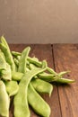 Raw green beans closeup. Fresh green bean also known as french beans, string beans, snap bean, snaps and haricots vert on wooden Royalty Free Stock Photo