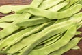 Raw green beans closeup. Fresh green bean also known as french beans, string beans, snap bean, snaps and haricots vert on wooden Royalty Free Stock Photo