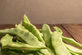 Raw green beans closeup. Fresh green bean also known as french beans, string beans, snap bean, snaps and haricots vert on wooden Royalty Free Stock Photo
