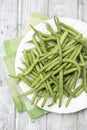 Raw green beans (Phaseolus vulgaris) on plate Royalty Free Stock Photo