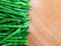 Raw green beans on wood background, close up, top view, copyspace