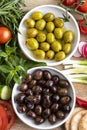 Raw green and black olive seeds and vegetables Royalty Free Stock Photo